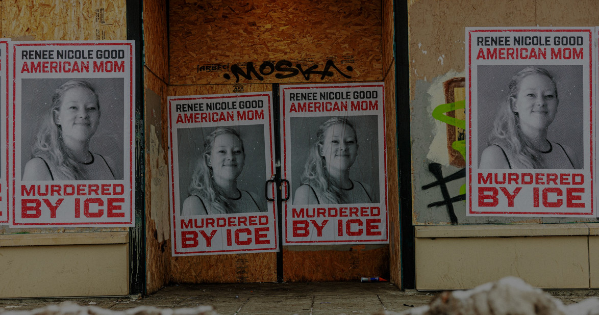 Posters with Renee Good's image decorate a building